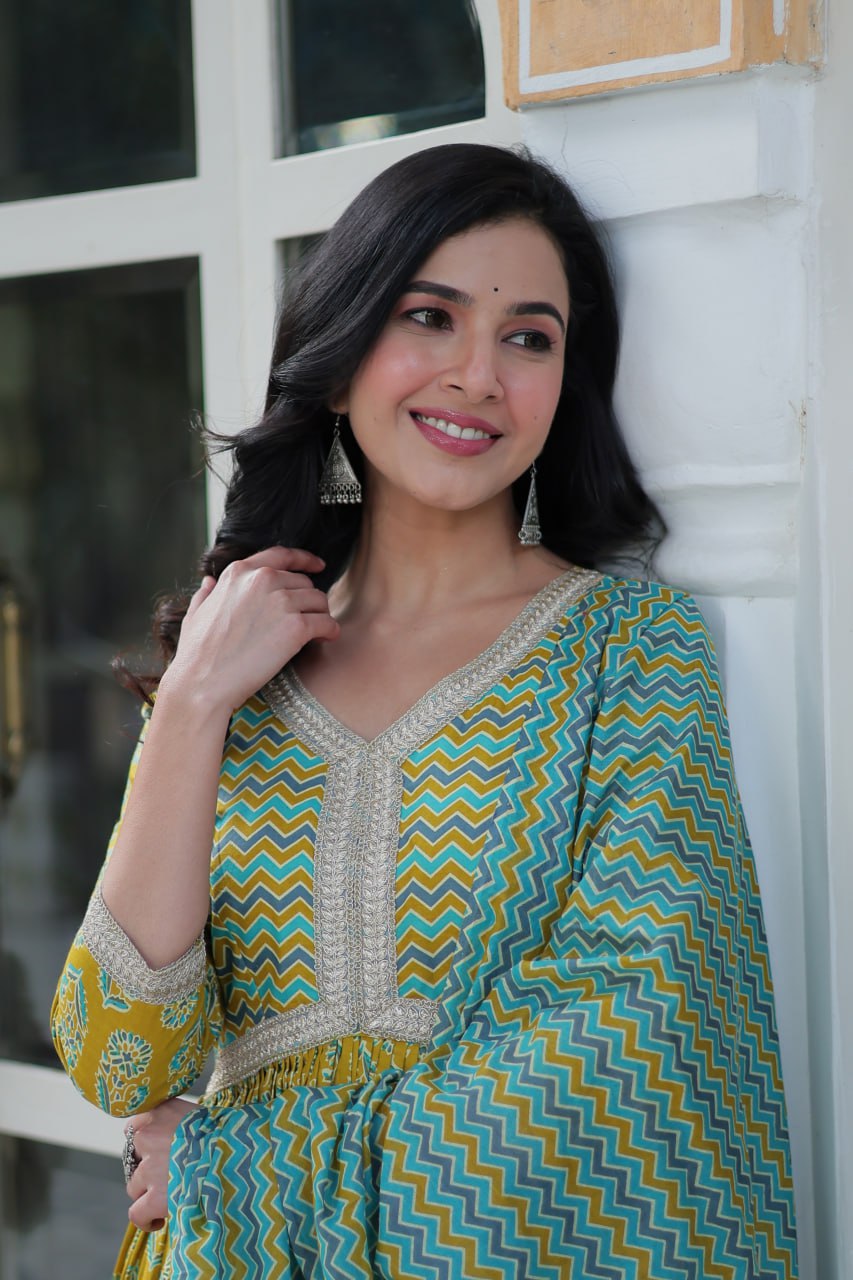 Mustard and teal Anarkali kurti set, chevron dupatta, block print, V-neck, model twirling outside.