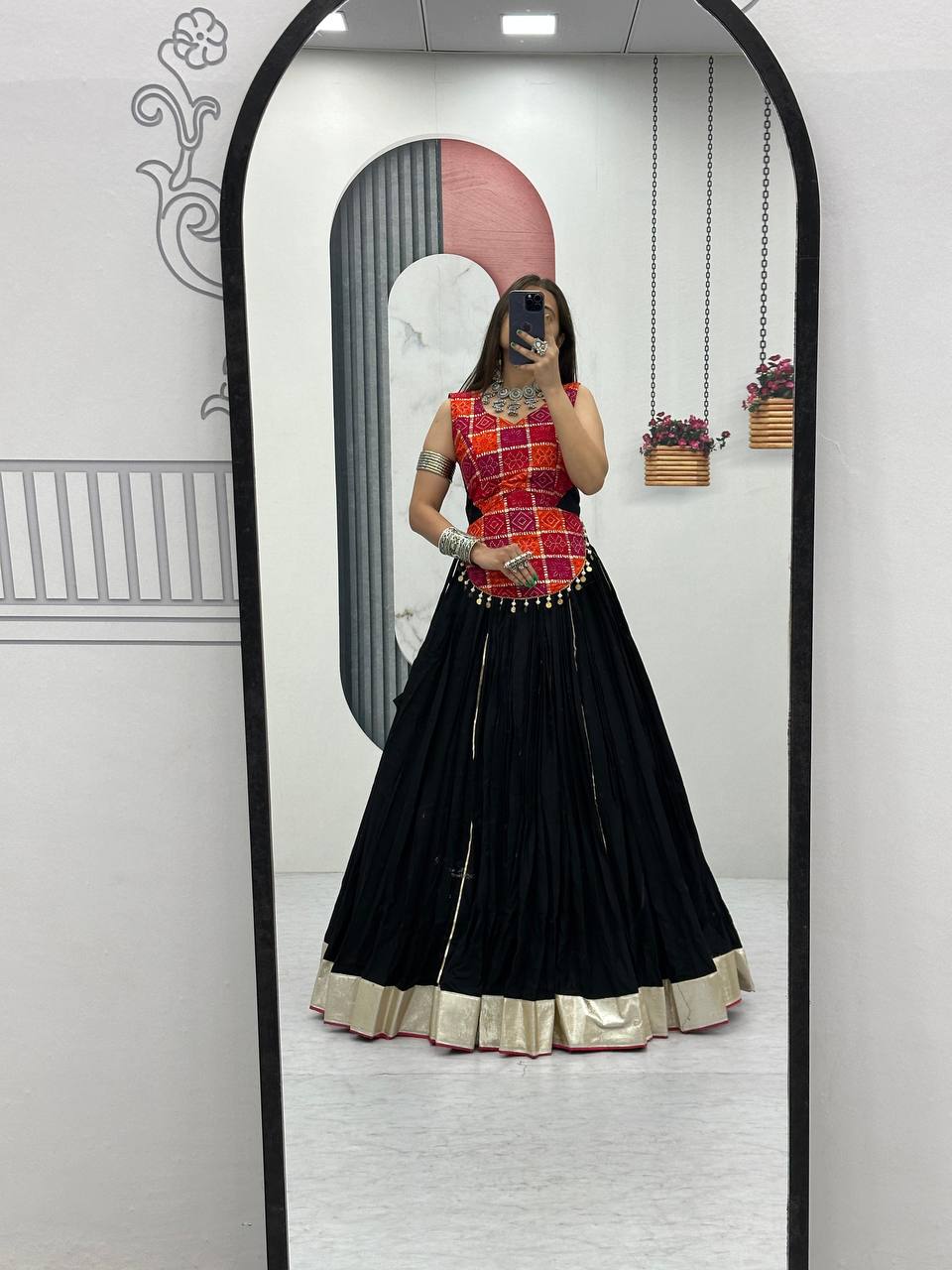 Full-length mirror photo of pure cotton lehenga choli set in black with gold border, Navratri style.