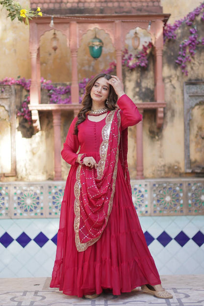 Woman in a red flared gown with a gold sequin embroidered dupatta, full shot.