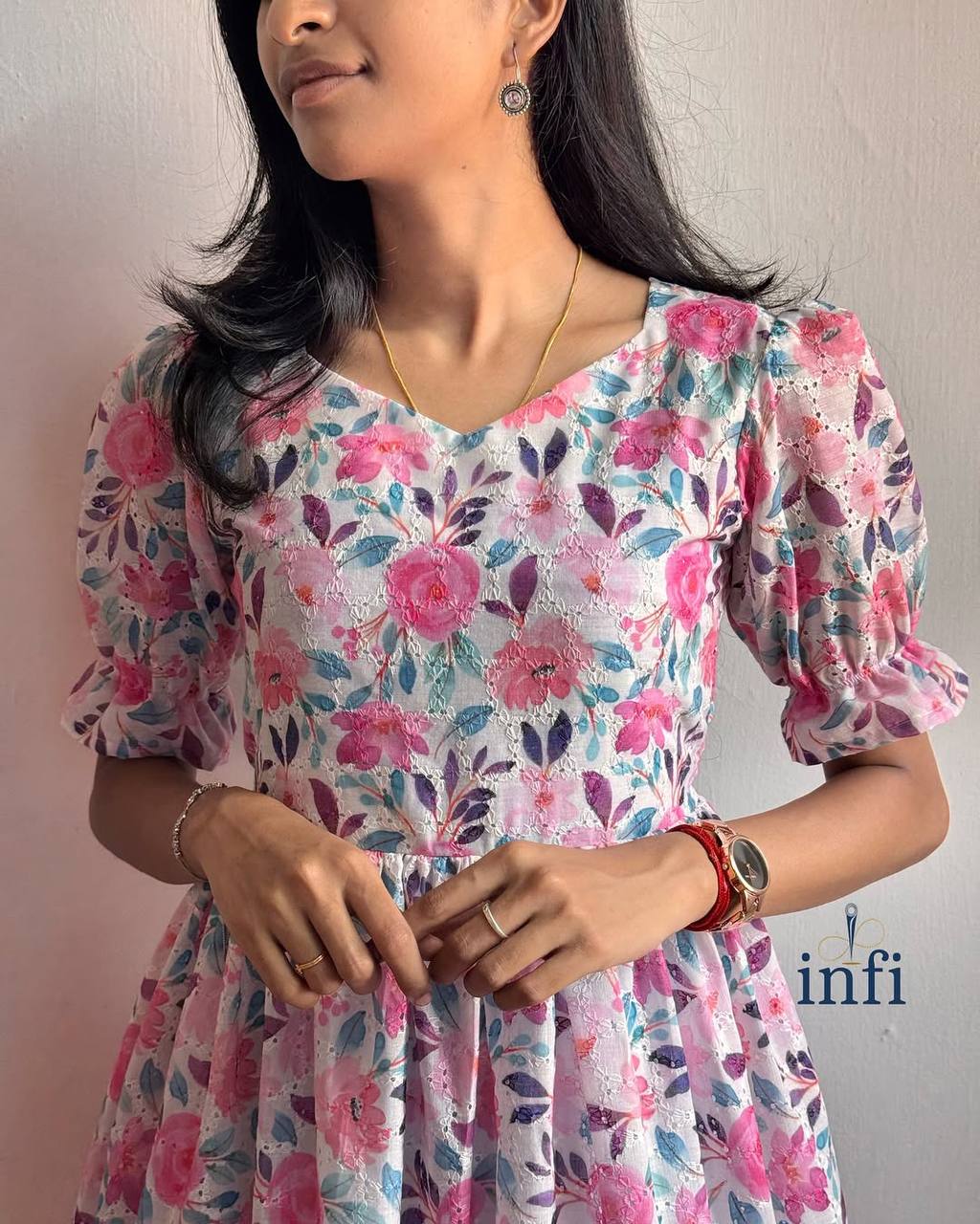 Close-up of Lily Dress: Showcasing the delicate floral pattern and ruffle sleeve detail.