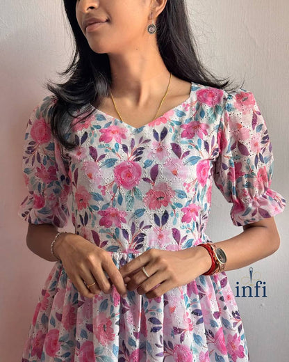 Close-up of Lily Dress: Showcasing the delicate floral pattern and ruffle sleeve detail.