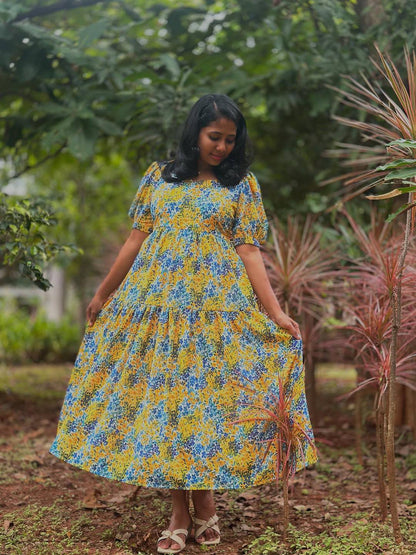 Flowing yellow and blue floral maxi dress made of lightweight georgette material.