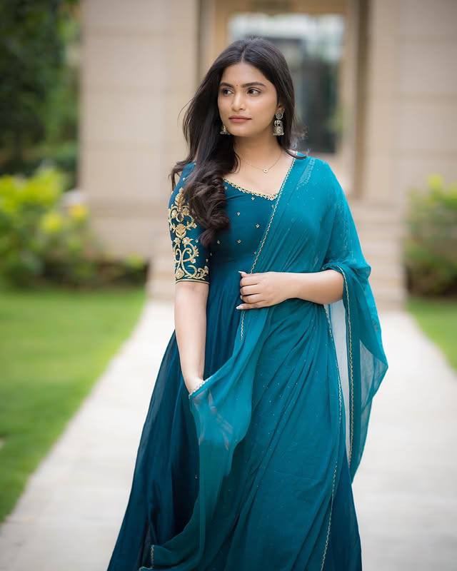 Model wearing teal Morpankh Anarkali and dupatta, looking away from camera.