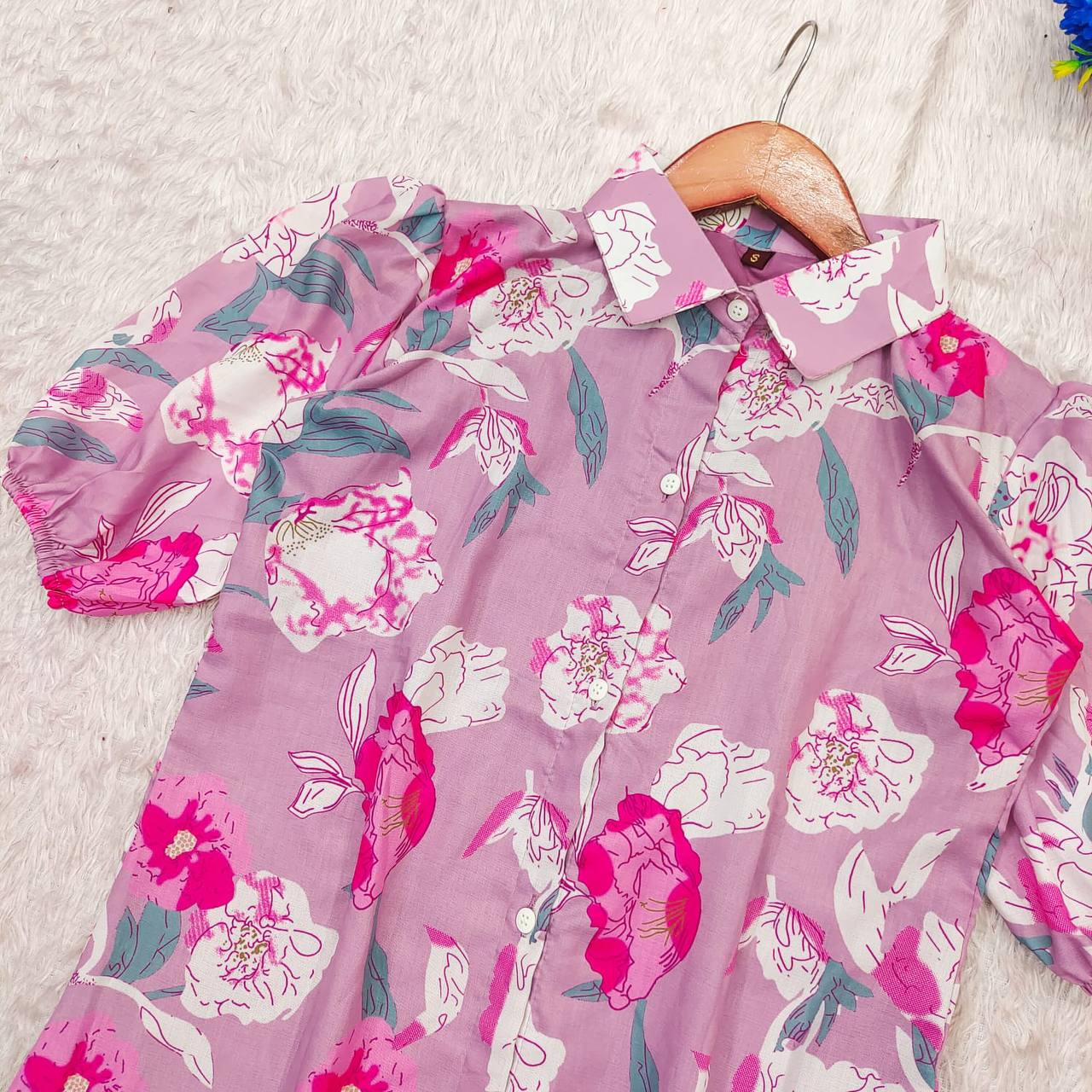 Close-up of the Lilac floral maxi dress on a hanger showcasing the floral print.
