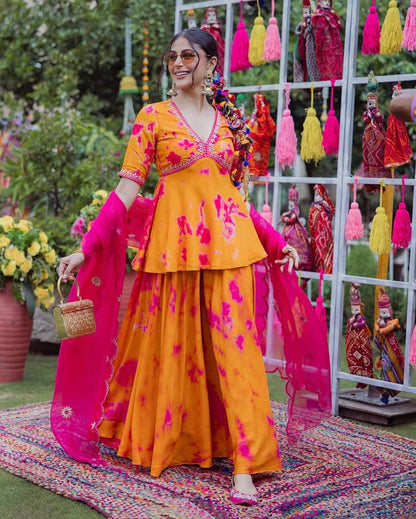 Model showcases vibrant printed top with wide-leg palazzo pants and flowing dupatta.