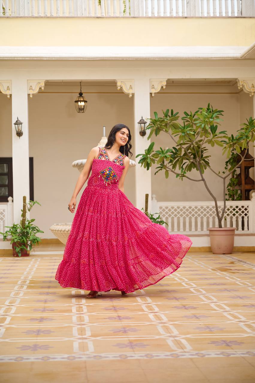 Woman dancing in pink Bandhani Gamathi gown, showing off the wide 12-meter flare.