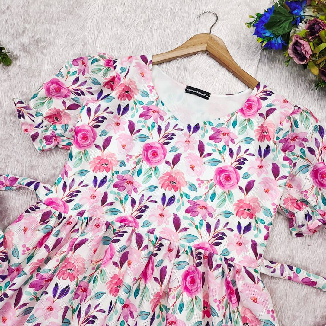 Lily Dress on hanger: A beautiful floral maxi dress with tie details.