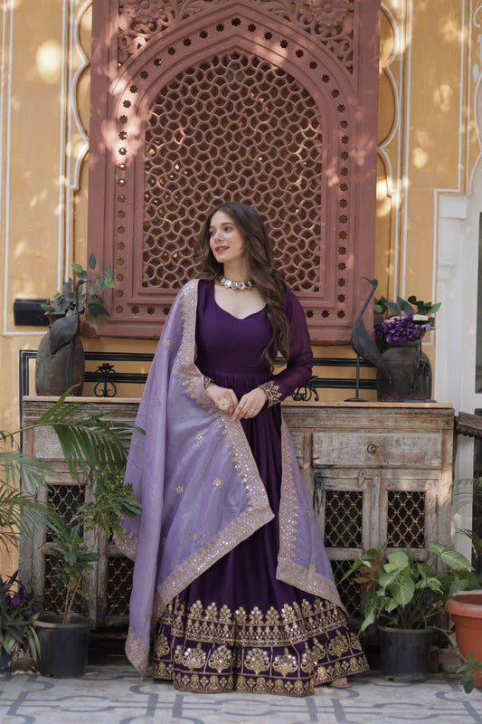 Elegant purple gown with gold embroidery and a light purple dupatta.