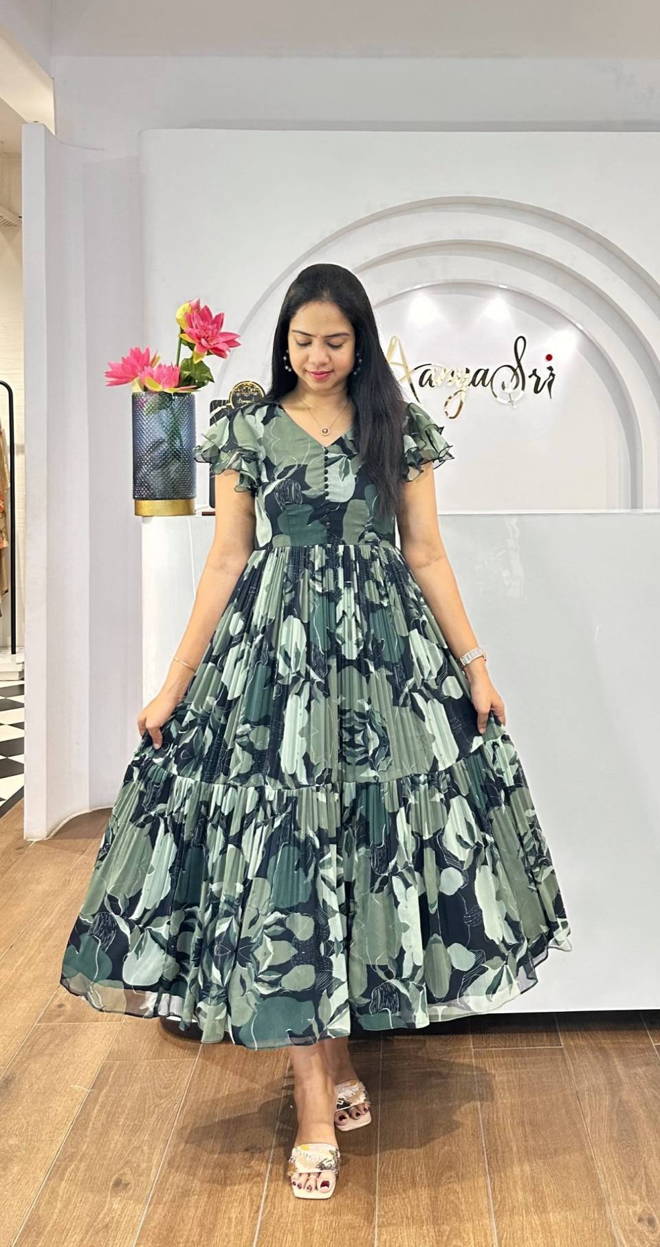 Woman wearing tiered floral Georgette maxi dress in boutique