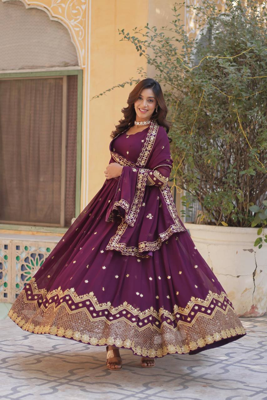 Plum Anarkali gown with gold embellishments, perfect for a festive look.