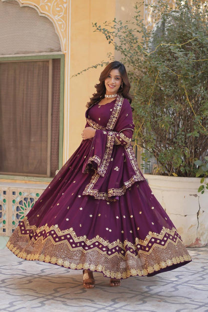 Plum Anarkali gown with gold embellishments, perfect for a festive look.