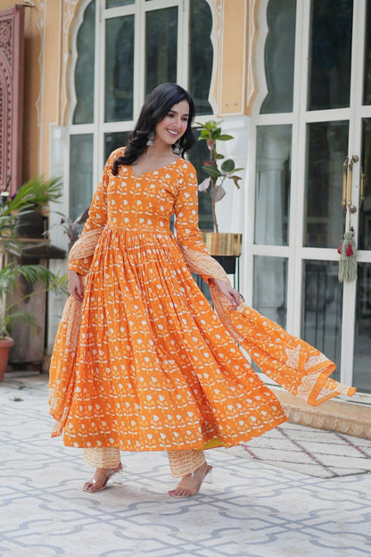 Model in orange floral pure cotton kurti set, posing gracefully with light, airy dupatta.