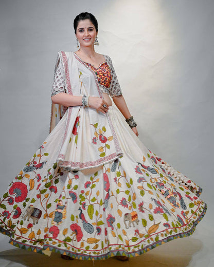 Woman twirling in Gamthi Grace Lehenga Choli, highlighting multicolored folk and floral skirt prints.