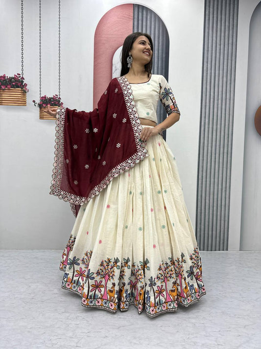 Smiling woman in ivory Rangbhoomi Lehenga with maroon dupatta. Festive cotton embroidery choli design.