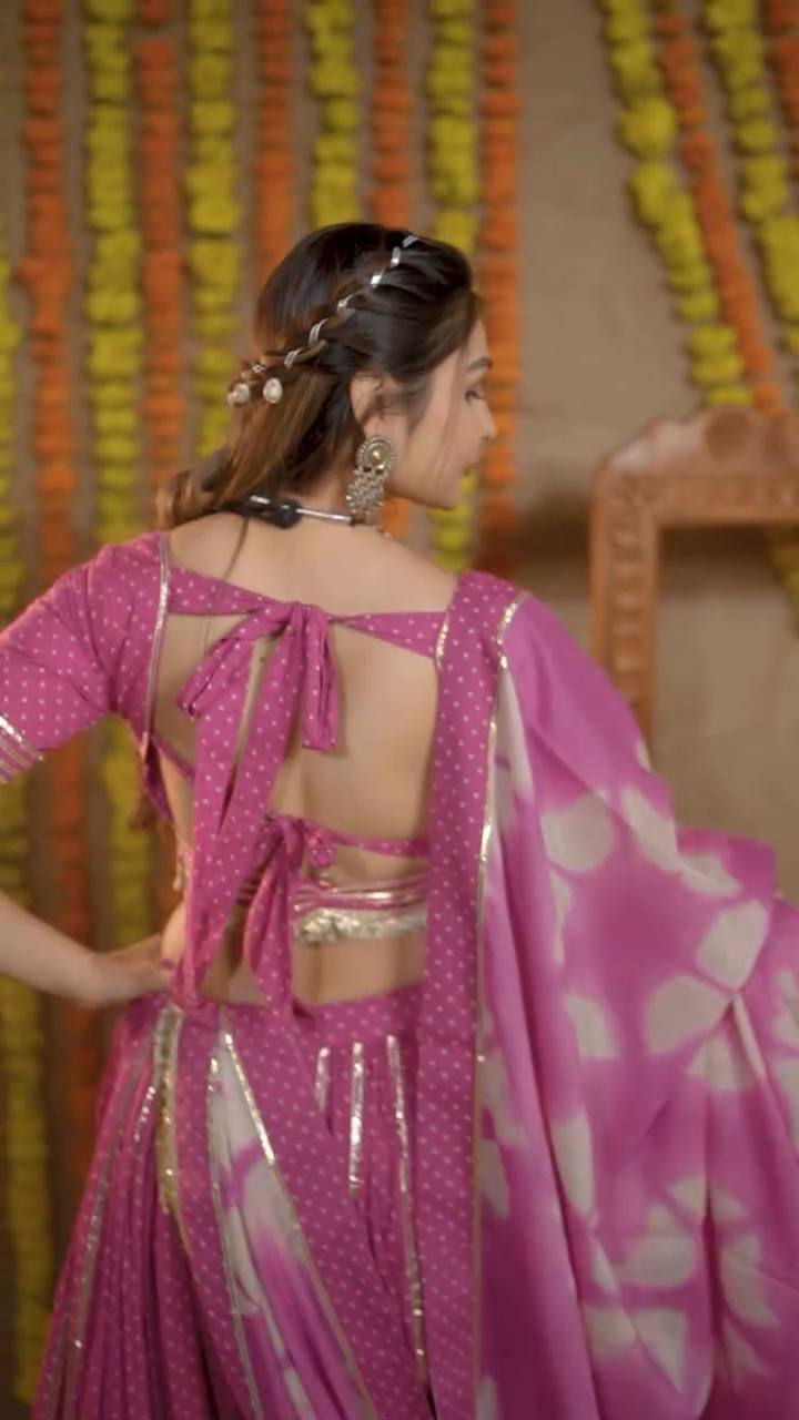 Back detail of the pink choli with double bow tie and gold border, paired with printed cotton dupatta.