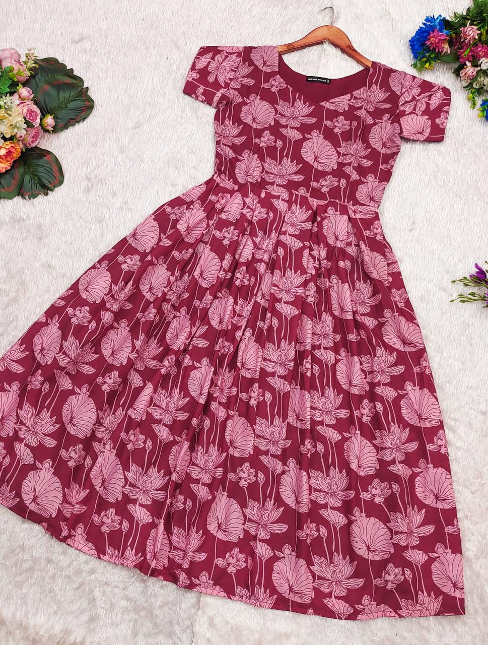 Full view of the Maroon Lotus dress. A-line floral dress with short sleeves and a frilled hem.