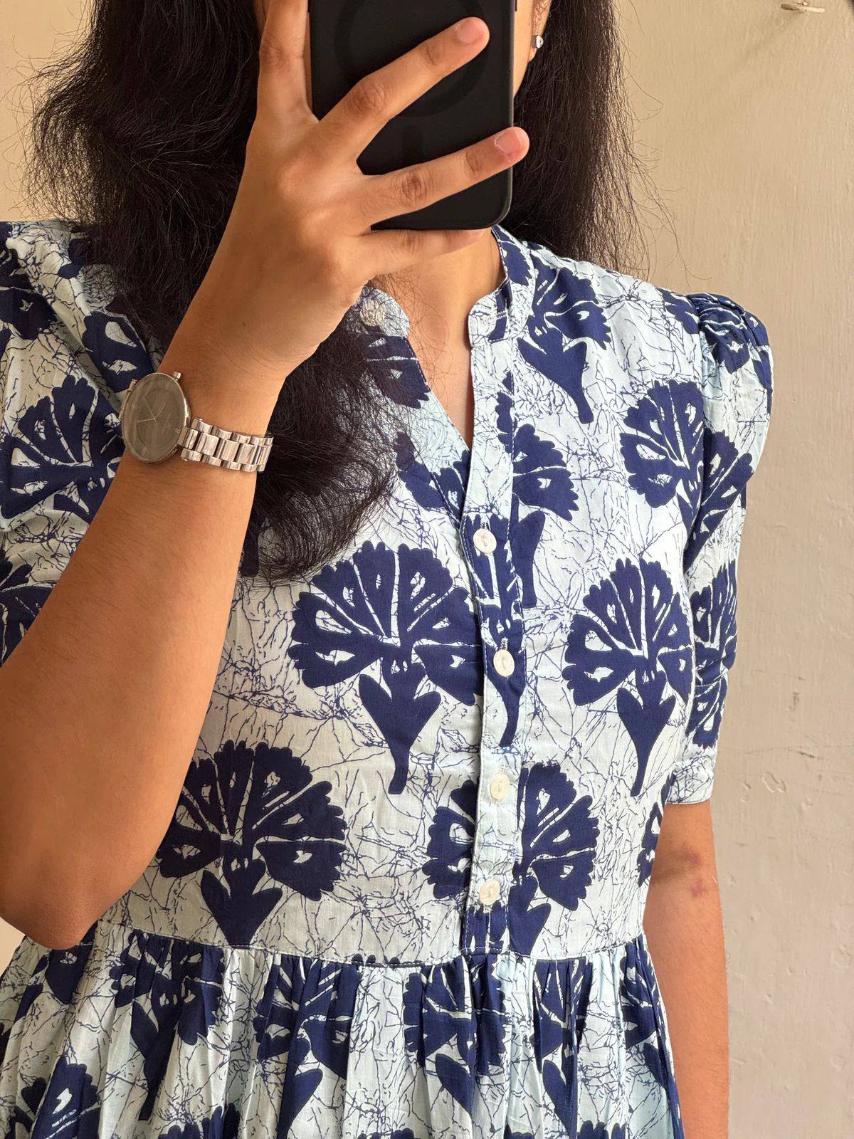 Detailed view of V-neck and floral print on soft cotton maxi dress.