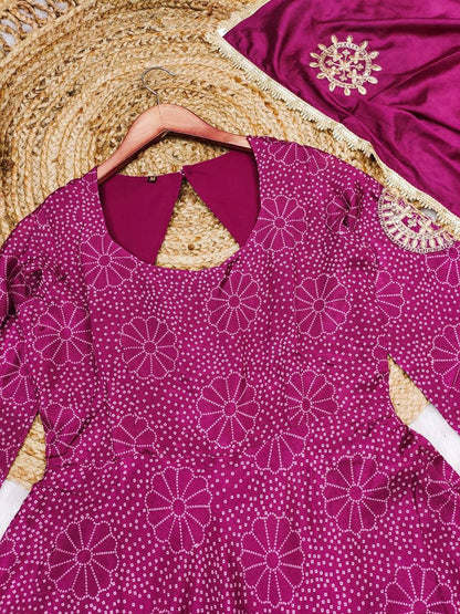 Stylish woman in a purple digital print gown with matching palazzo and dupatta.