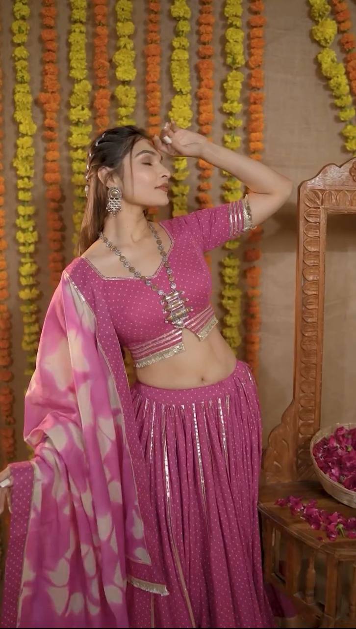 Woman in pink lehenga choli set, posing gracefully with dupatta and oxidized jewelry, Navratri ready.