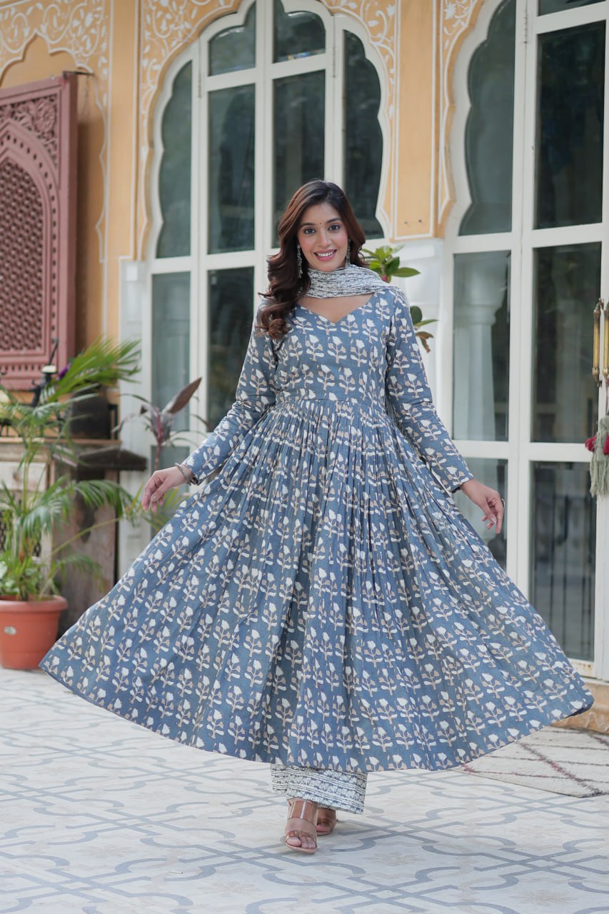 Model swirling in a blue floral cotton kurti, flared skirt and elastic pants visible for a playful look.