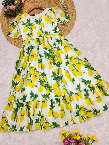 Flowing lemon print maxi dress with a ruffled hem on display.