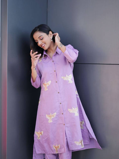 Smiling woman wearing lavender embroidered Kurti Palazzo set.