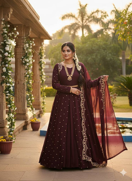 Elegant wine Anarkali gown with gold embroidery and matching dupatta on a model.