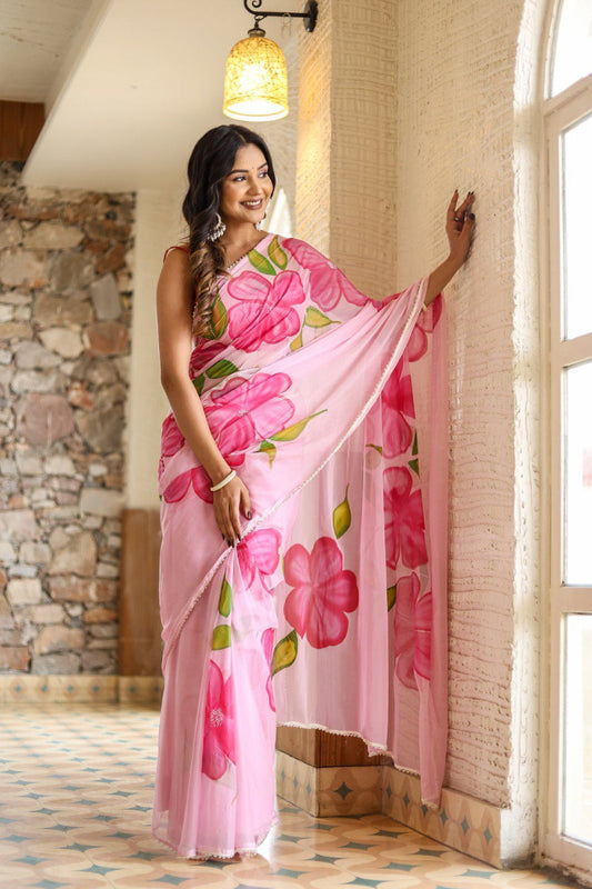 Woman wearing a pink floral georgette ready-to-wear saree, looking elegant.