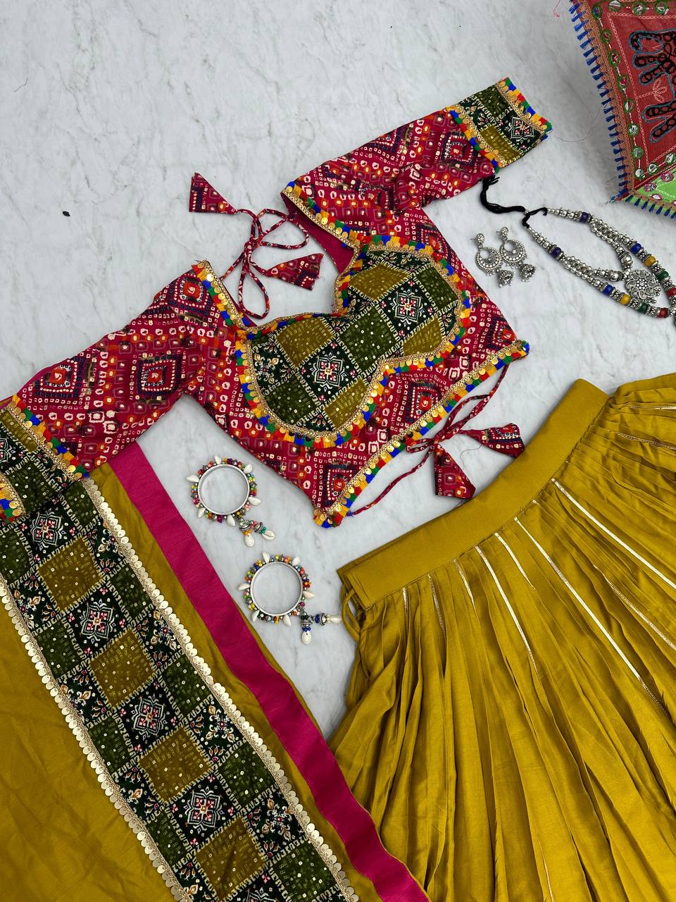 Complete Golden Gamthi lehenga set displayed with colorful umbrella and accessories.
