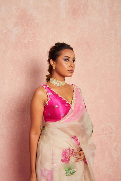 Sheer pink organza silk saree featuring delicate floral design.