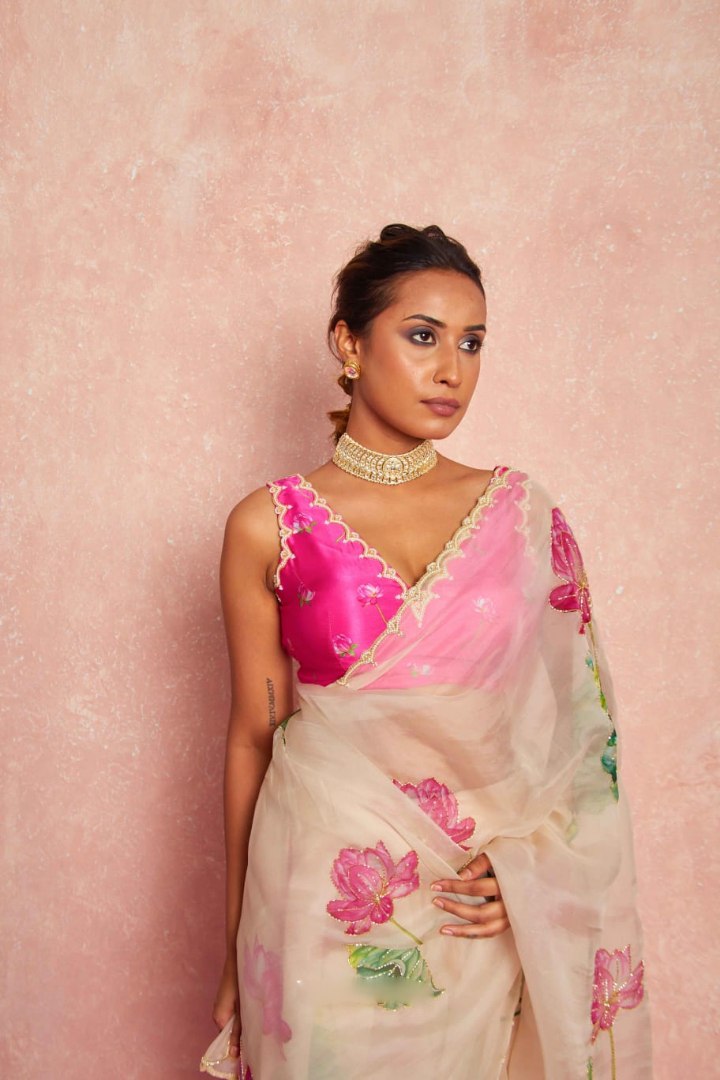 Close-up: floral print detail on the sheer pink organza silk saree.