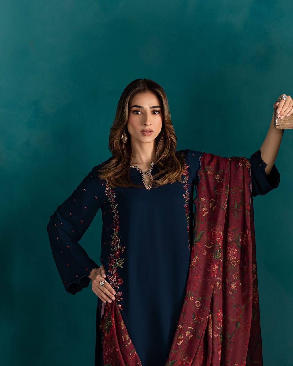 Close-up of embroidered neckline and maroon digital print dupatta on navy blue party wear set.