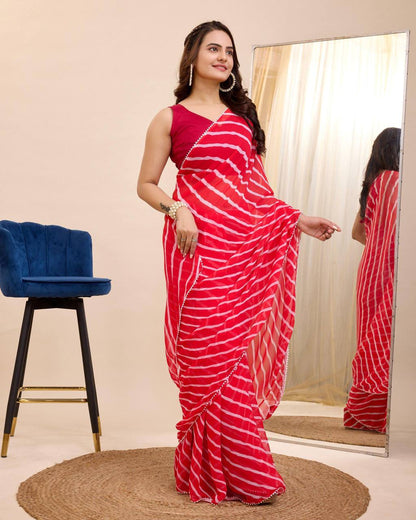 Elegant red georgette leheriya print saree with a sleeveless blouse for festive occasions.