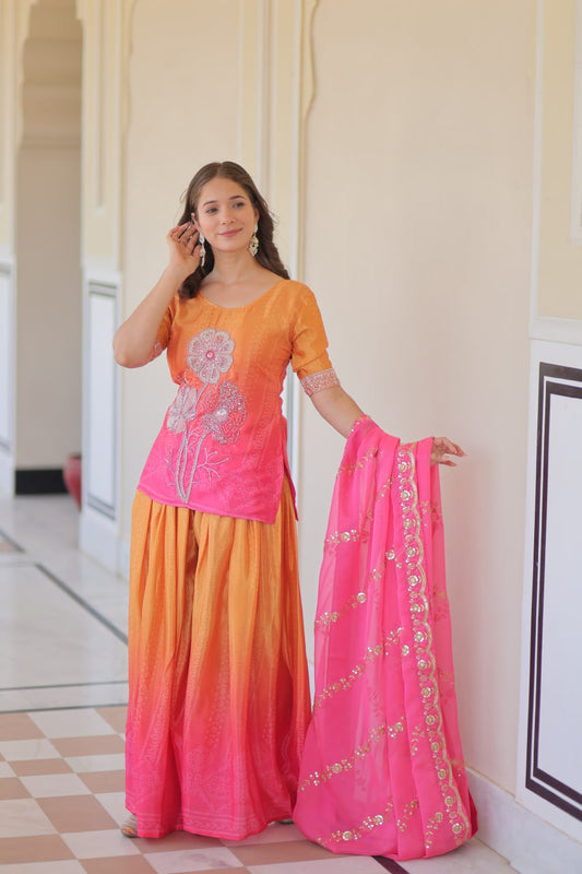 Model wearing orange and pink Sharara Suit with Dupatta