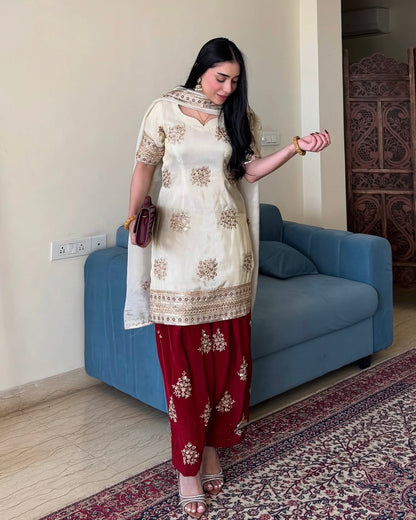 Model wearing cream and maroon embroidered party wear by Rangbhoomi.