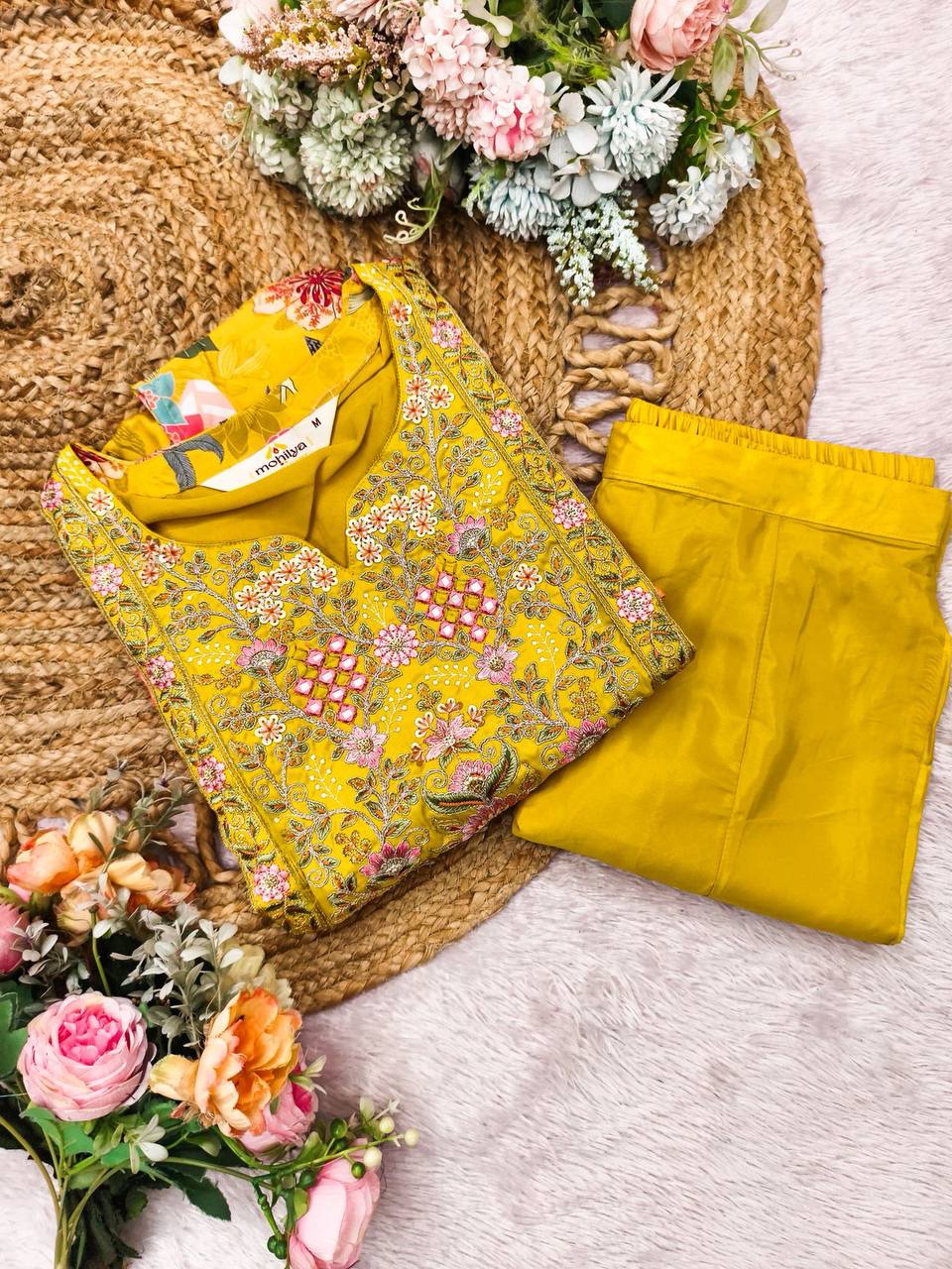Yellow heavy crepe kaftan with pink floral embroidery and matching palazzo pants on a woven mat.