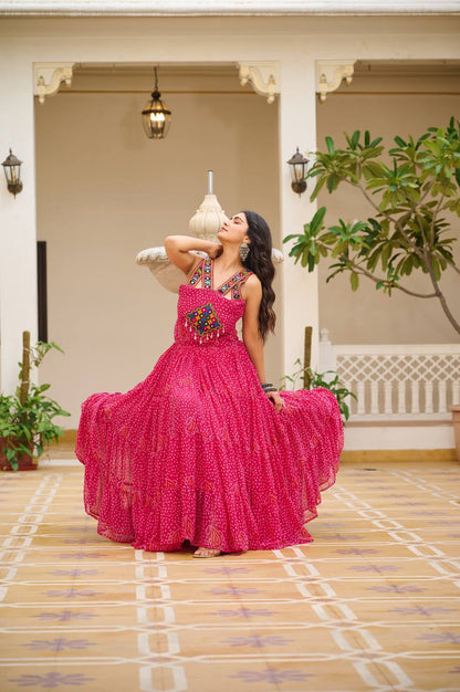 Pink Bandhani Gamathi gown with mirror work, twirl-ready and perfect for celebrations.