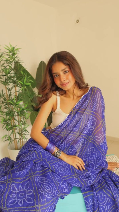 Model in flowing blue georgette saree, enjoying the light and airy fabric.