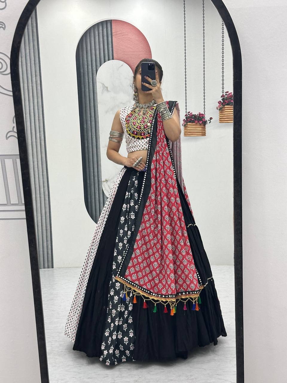 Full-length mirror selfie of multi-panel Navratri lehenga choli set with tassel dupatta and folk prints.