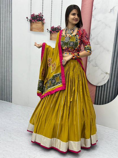 Woman wearing Golden Gamthi cotton lehenga choli with vibrant dupatta and traditional jewelry.