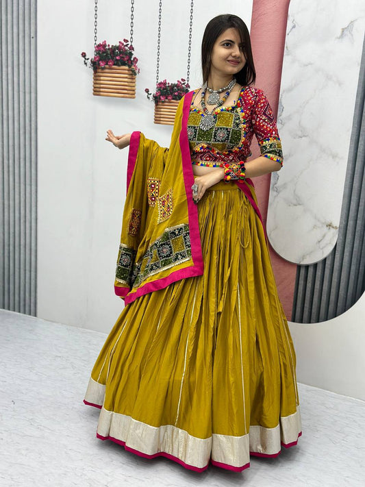 Woman wearing Golden Gamthi cotton lehenga choli with vibrant dupatta and traditional jewelry.