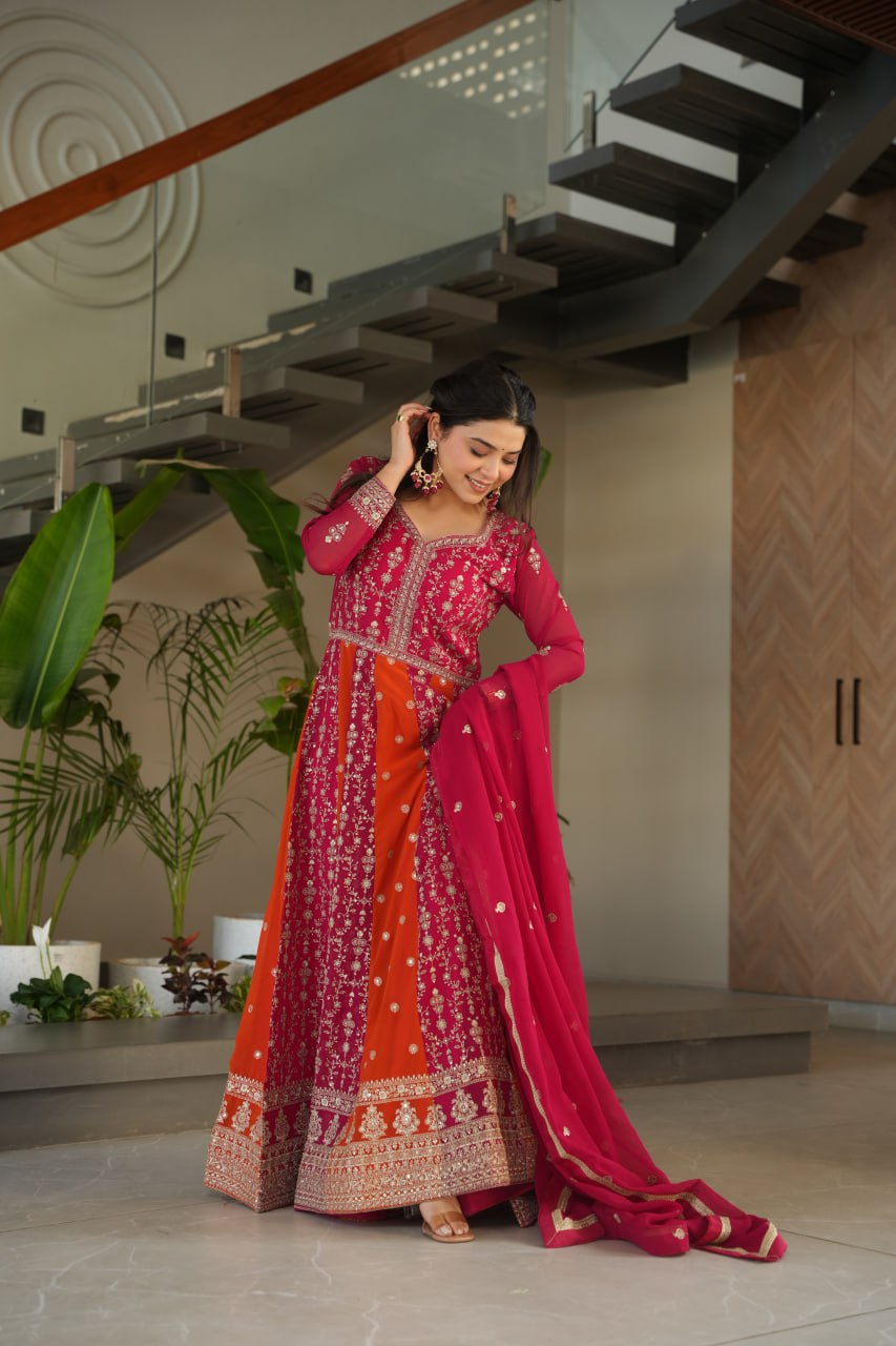 Woman modeling a pink and orange zari and sequin embroidered gown.