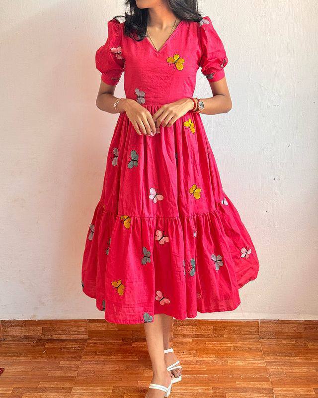 Full shot of the pink Butterfly Maxi Dress highlighting the butterfly print and flared design.