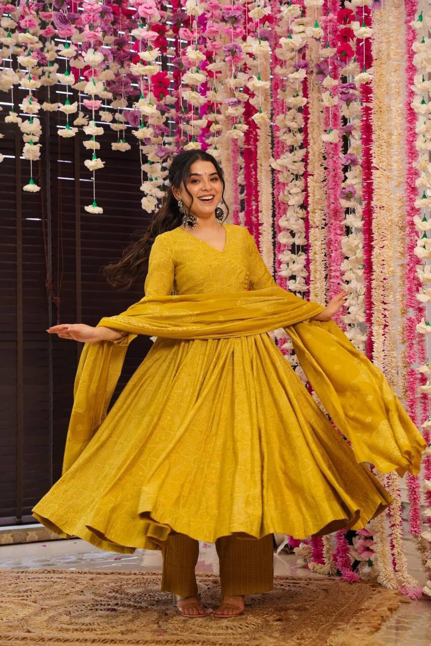Woman twirling in Golden Bandhani Anarkali Suit Set. Ethnic dress.