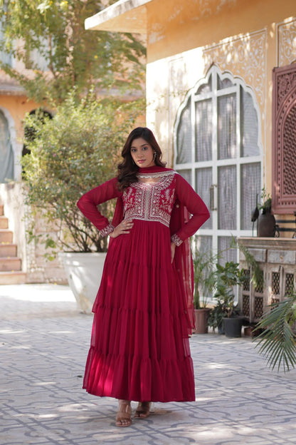 Woman in a red embroidered Georgette gown with dupatta.