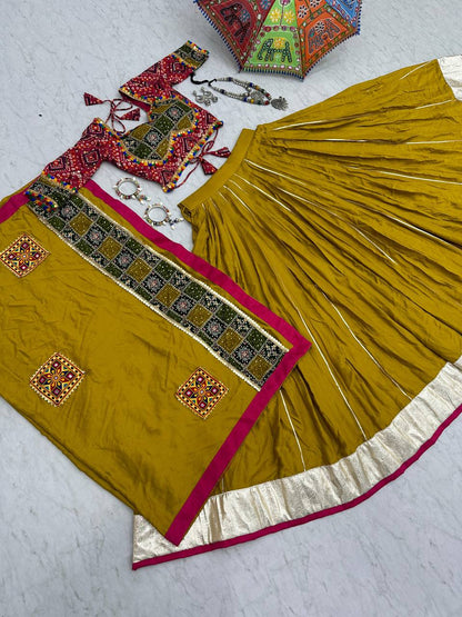 Golden yellow Navratri lehenga, choli, and dupatta flat lay with silver and beaded jewelry.