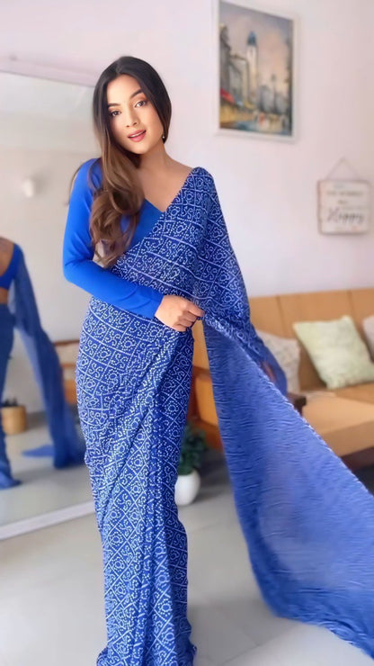Elegant woman wearing a ready to wear blue georgette saree with subtle print.