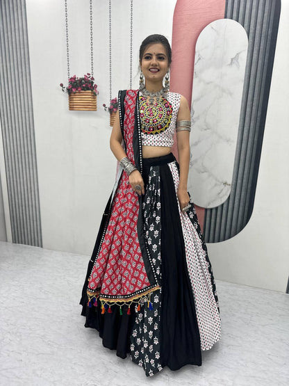 Model in Navratri lehenga choli with red dupatta, black and white flair, and bold mirror necklace.