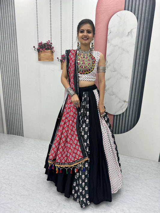 Model in Navratri lehenga choli with red dupatta, black and white flair, and bold mirror necklace.