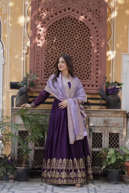 Model wearing an embroidered purple gown and light purple dupatta.